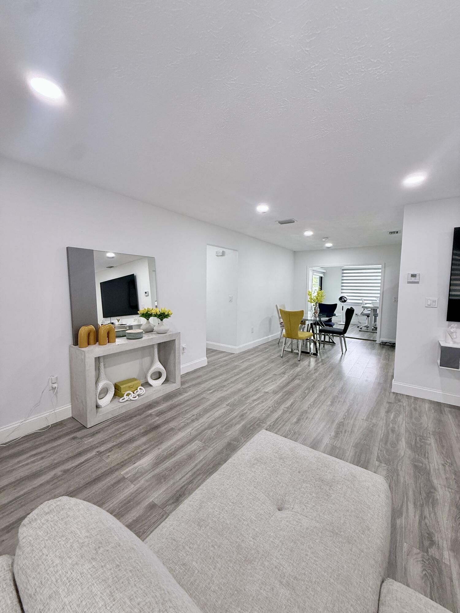 302 Southwest Whitmore Drive Port St. Lucie, FL 34984 - Photo 3 of 21 a living room with furniture and a flat screen tv