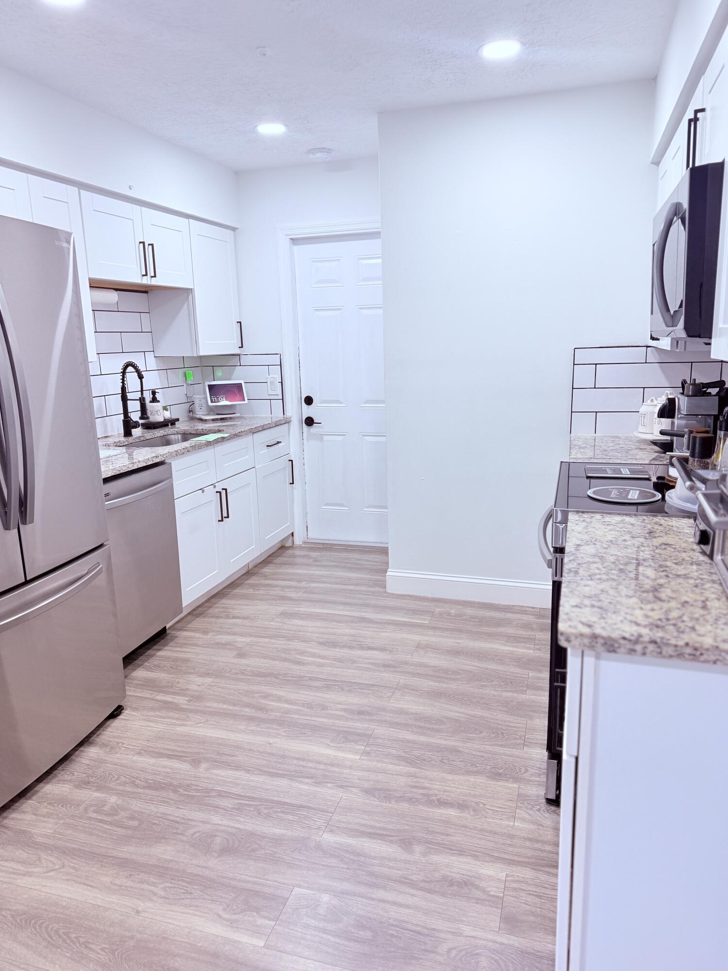 302 Southwest Whitmore Drive Port St. Lucie, FL 34984 - Photo 6 of 21 a kitchen with stainless steel appliances granite countertop a sink stove and refrigerator