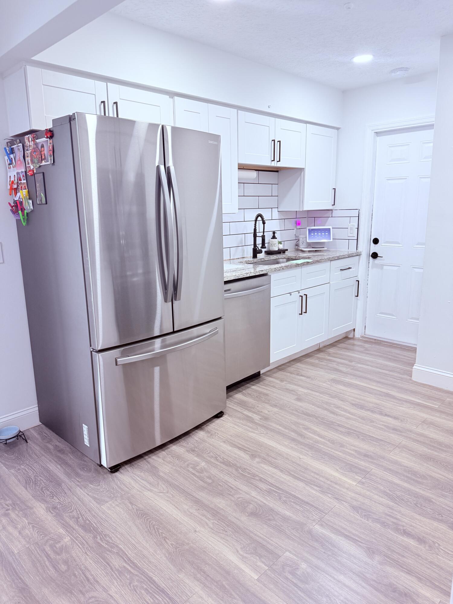 302 Southwest Whitmore Drive Port St. Lucie, FL 34984 - Photo 8 of 21 a kitchen with stainless steel appliances a refrigerator sink and cabinets