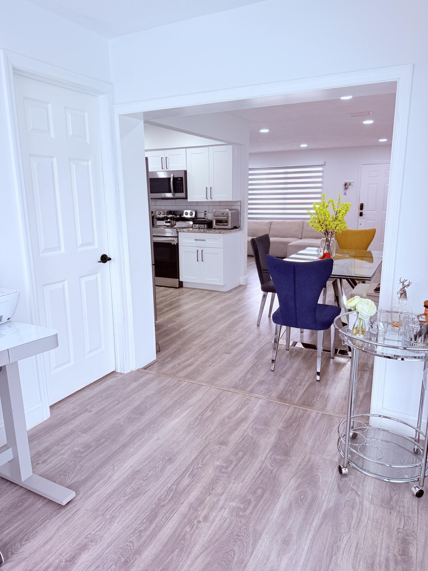 302 Southwest Whitmore Drive Port St. Lucie, FL 34984 - Photo 9 of 21 a view of kitchen with furniture and wooden floor