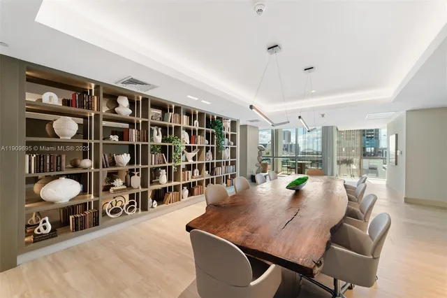 a dining room with furniture and a book shelf