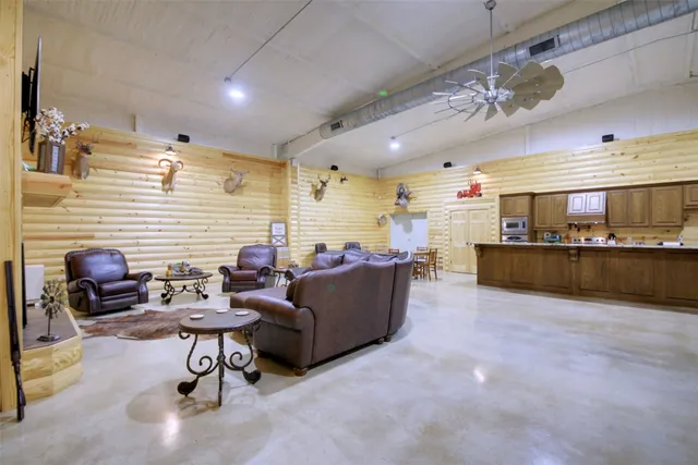 a living room with furniture and kitchen view
