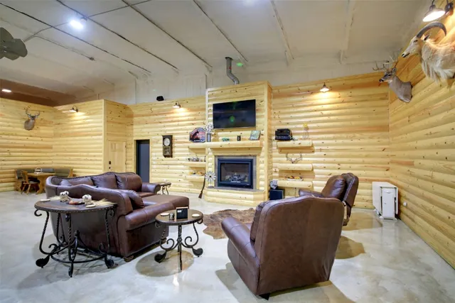 a living room with furniture flat screen tv and a fireplace
