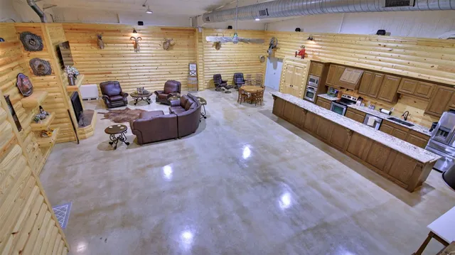 a living room with furniture a fireplace a flat screen tv and a counter top