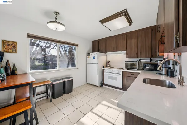 a kitchen with a stove a sink and a refrigerator