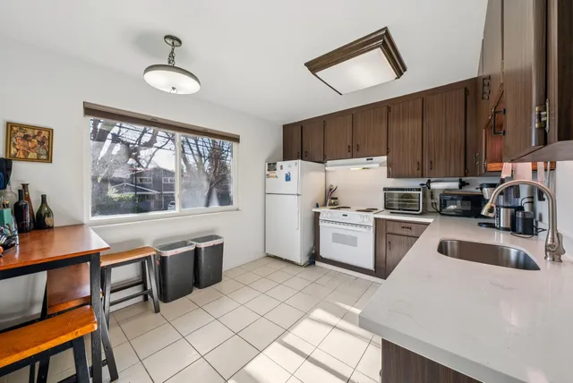 a kitchen with a stove a sink and a refrigerator