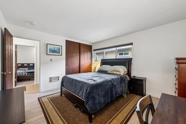 a bedroom with a bed and dresser