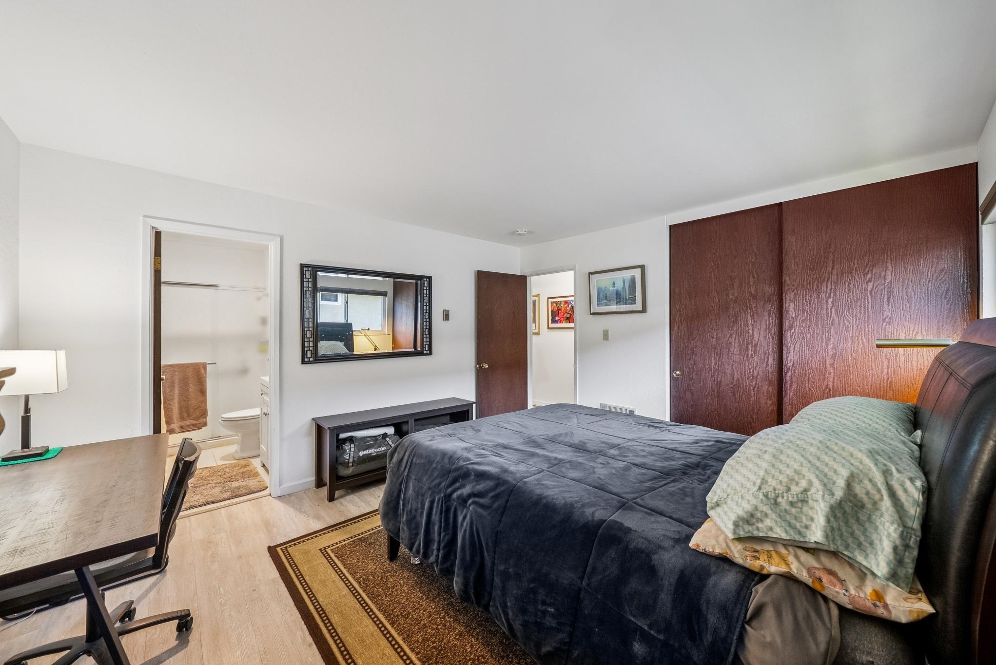 1401 Cottage Street, Unit D Alameda, CA 94501 - Photo 15 of 25 a bedroom with a bed and wooden floor