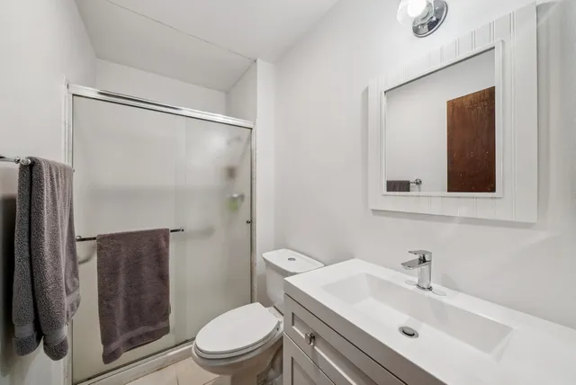 a bathroom with a sink toilet and shower