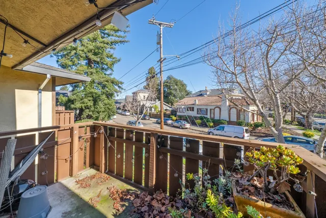 a view of a house with a wooden fence