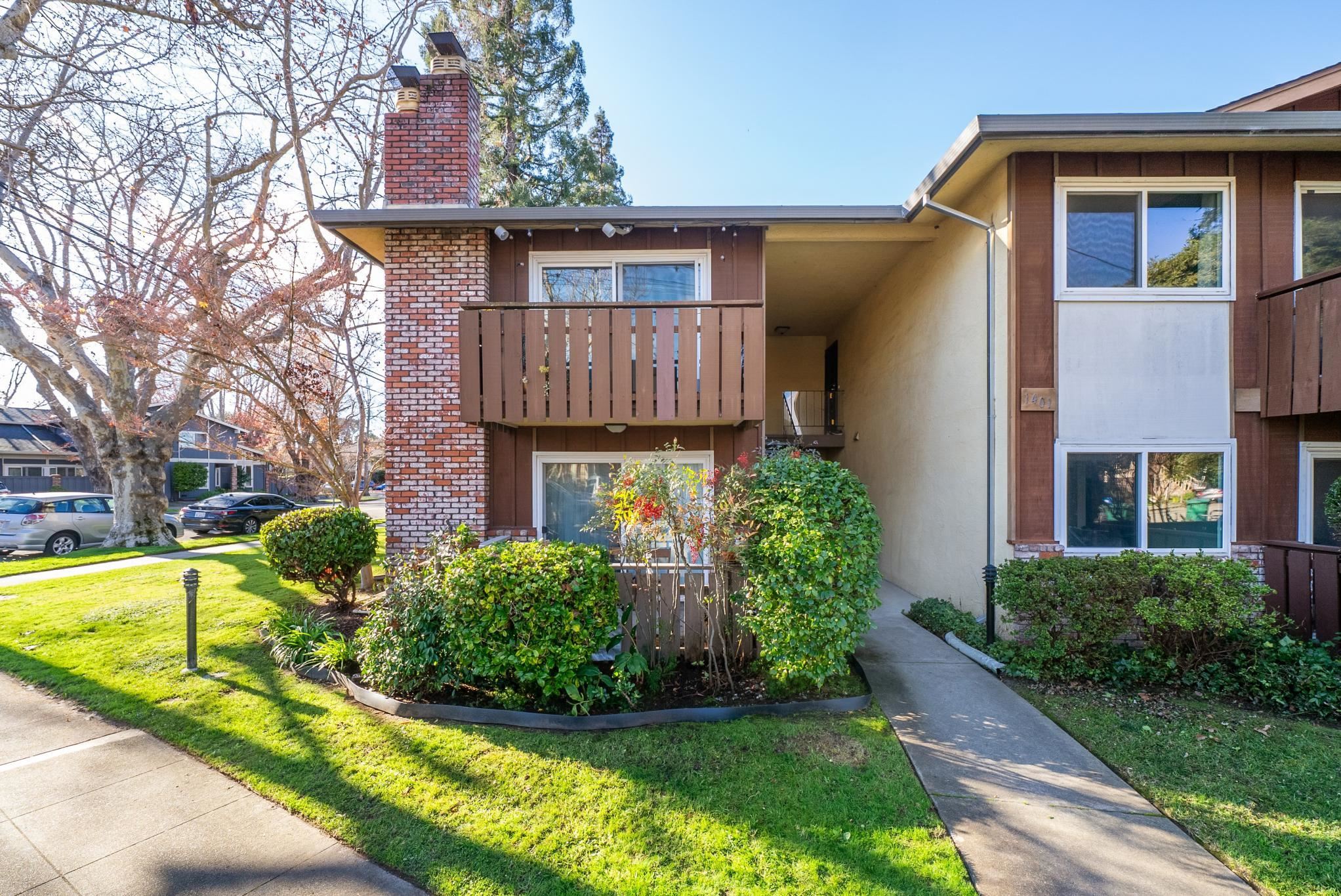 1401 Cottage Street, Unit D Alameda, CA 94501 - Photo 21 of 25 a view of a house with brick walls and a yard with plants