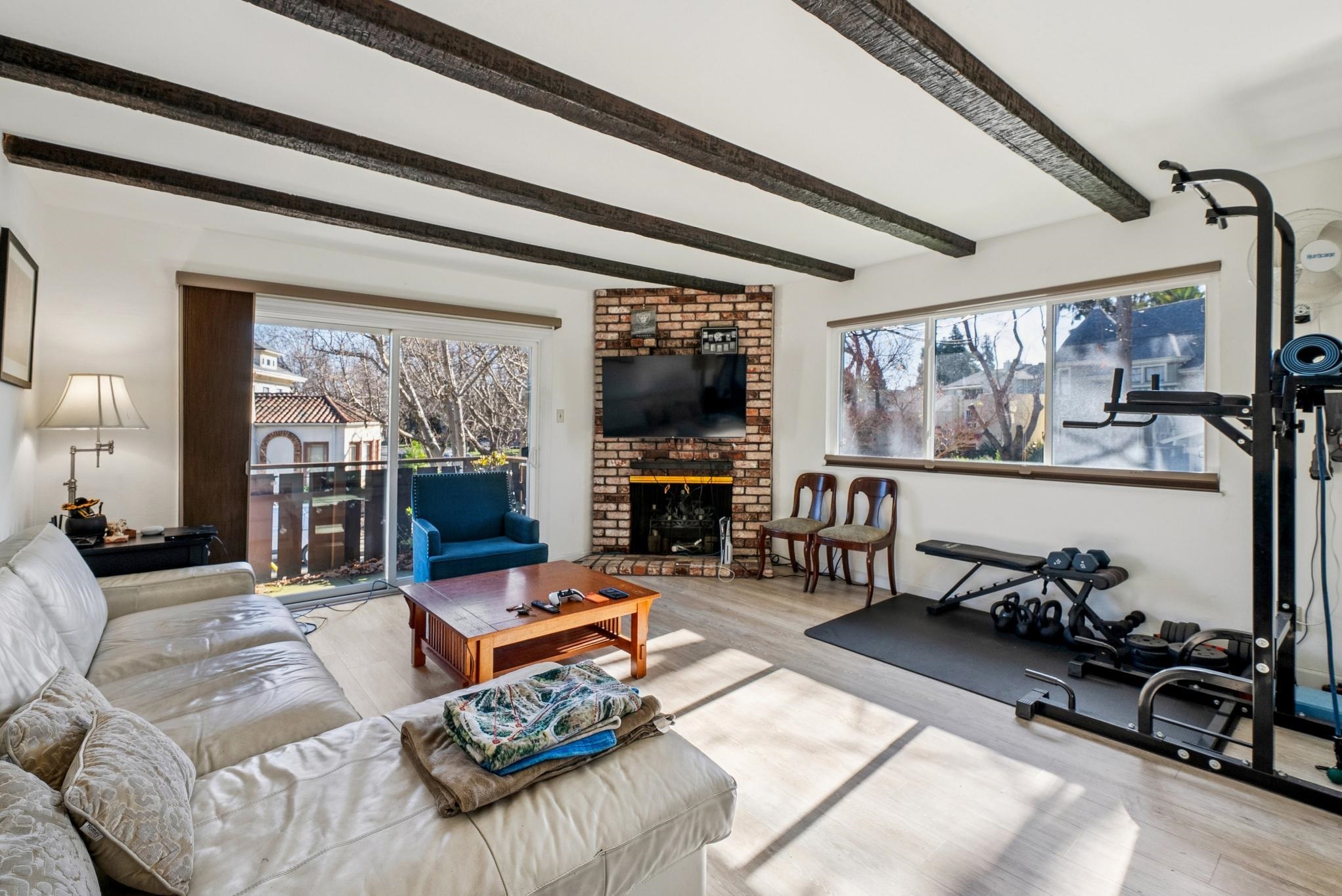 1401 Cottage Street, Unit D Alameda, CA 94501 - Photo 5 of 25 a living room with furniture gym equipment and a large window