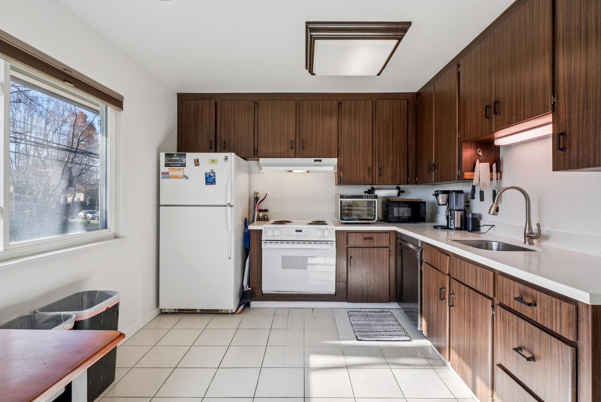 1401 Cottage Street, Unit D Alameda, CA 94501 - Photo 10 of 25 a kitchen with a refrigerator sink and cabinets