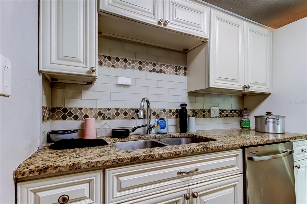 4532 Devonshire Road Tampa, FL 33634 - Photo 13 of 37 a kitchen with stainless steel appliances granite countertop a sink and cabinets