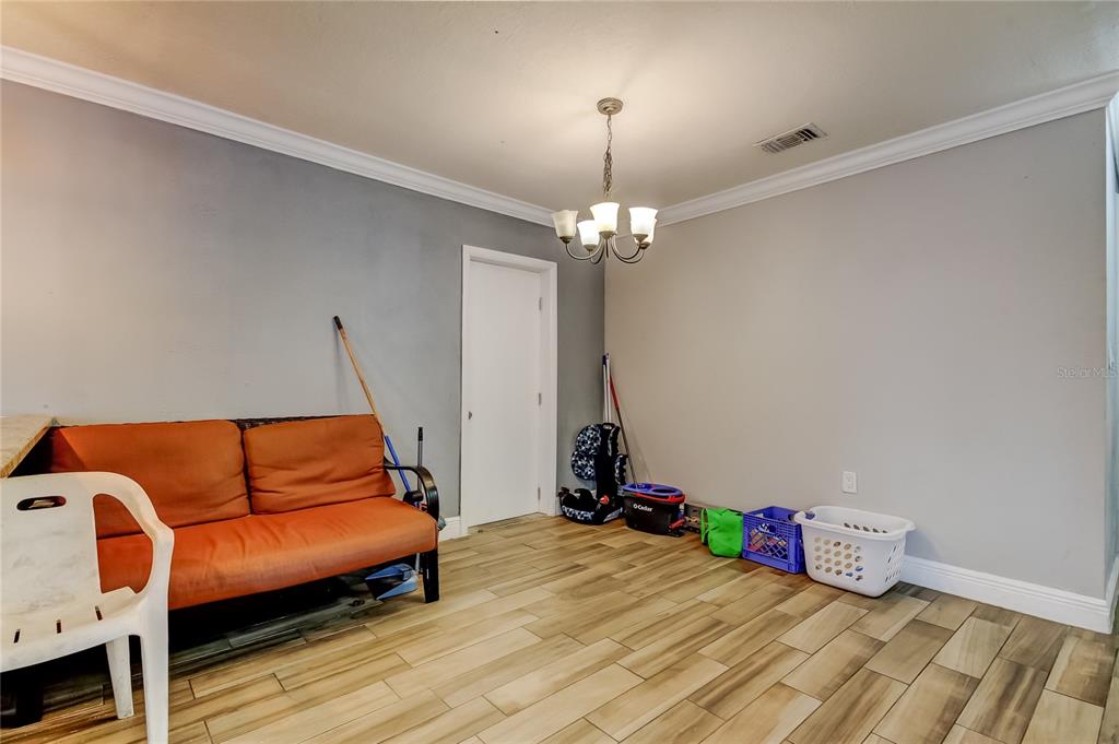 4532 Devonshire Road Tampa, FL 33634 - Photo 15 of 37 a view of a room with furniture and wooden floor