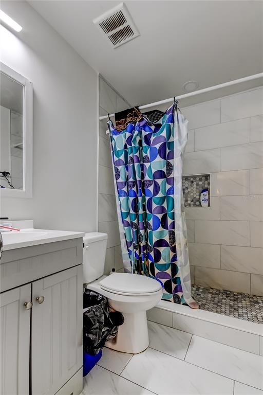4532 Devonshire Road Tampa, FL 33634 - Photo 19 of 37 a bathroom with a sink toilet and shower