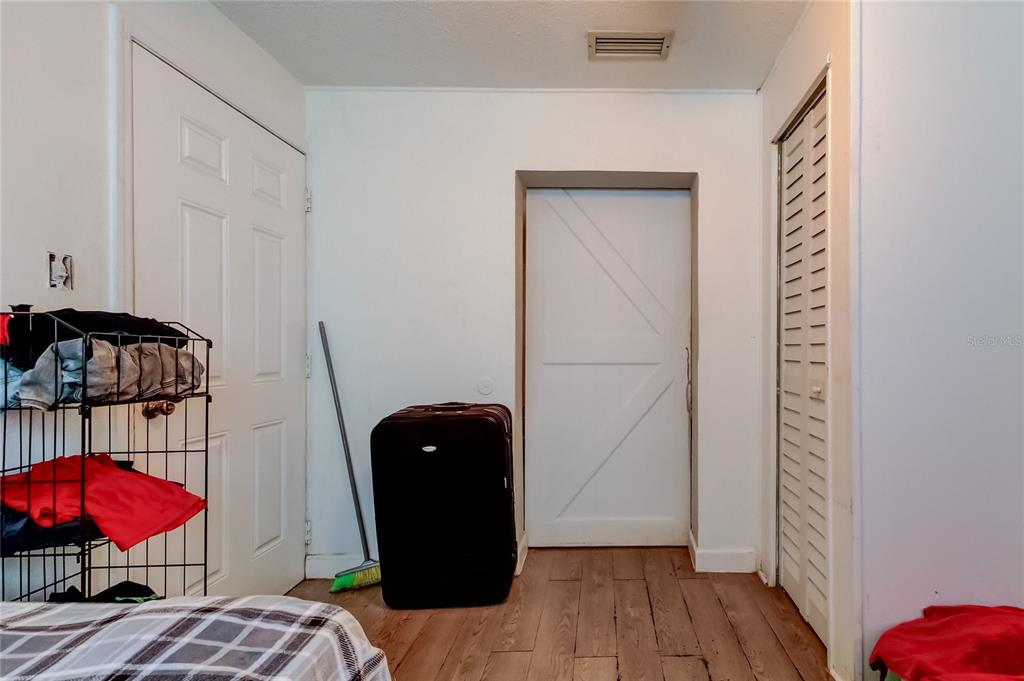 4532 Devonshire Road Tampa, FL 33634 - Photo 29 of 37 a view of a room with wooden floor and furniture