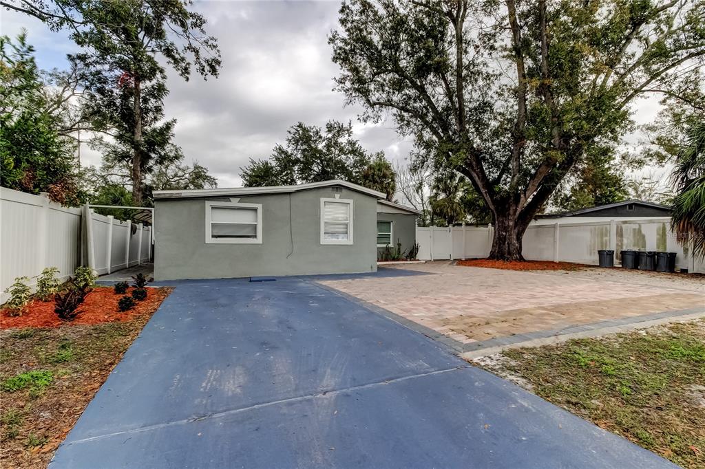 4532 Devonshire Road Tampa, FL 33634 - Photo 3 of 37 a view of a house with a backyard and a tree
