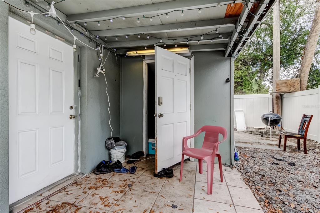 4532 Devonshire Road Tampa, FL 33634 - Photo 34 of 37 a view of a porch with a table and chairs