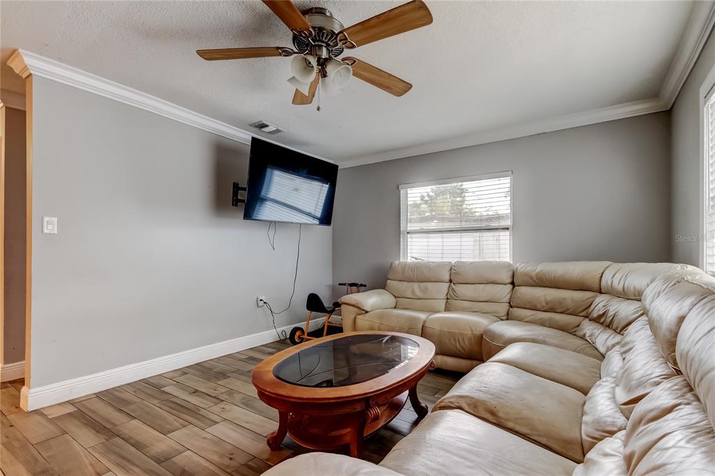 4532 Devonshire Road Tampa, FL 33634 - Photo 4 of 37 a living room with furniture a window and a flat screen tv
