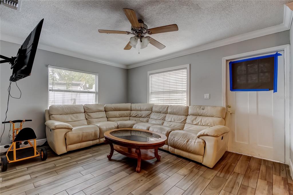 4532 Devonshire Road Tampa, FL 33634 - Photo 5 of 37 a living room with furniture and a wooden floor