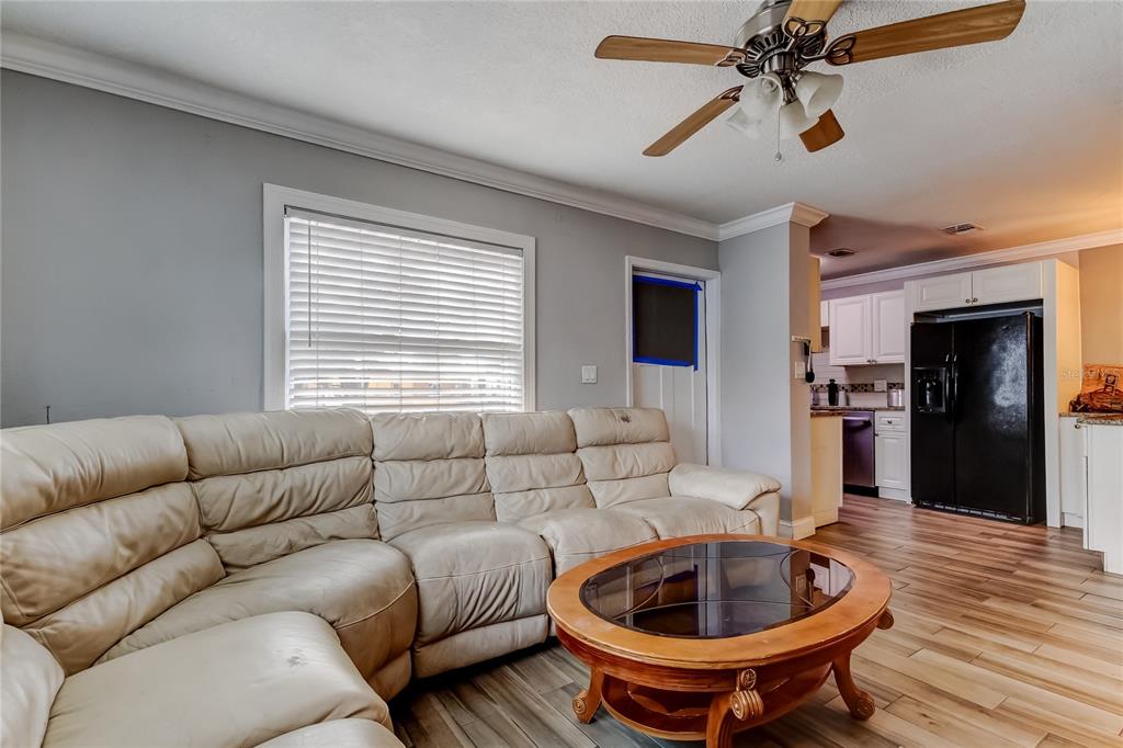 4532 Devonshire Road Tampa, FL 33634 - Photo 6 of 37 a living room with furniture and a wooden floor