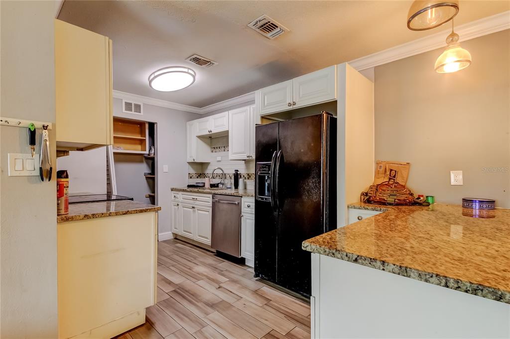 4532 Devonshire Road Tampa, FL 33634 - Photo 8 of 37 a kitchen with a refrigerator a stove top oven a sink and dishwasher