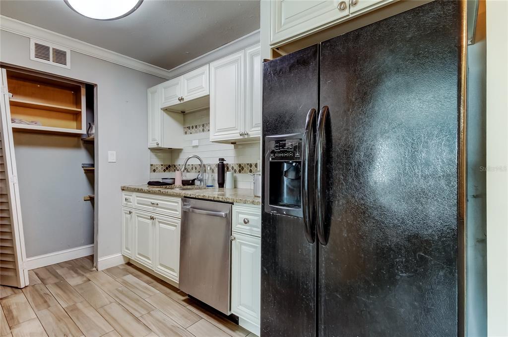 4532 Devonshire Road Tampa, FL 33634 - Photo 10 of 37 a kitchen with stainless steel appliances granite countertop a refrigerator and a stove
