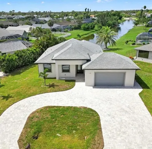 an aerial view of a house with pool