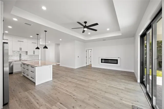 a view of kitchen with sink and refrigerator