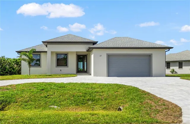 a front view of a house with a garden and yard