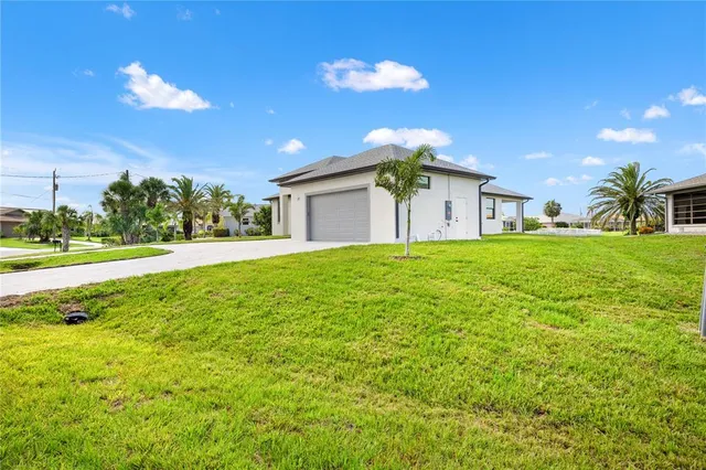 a view of a house with a big yard and a large tree