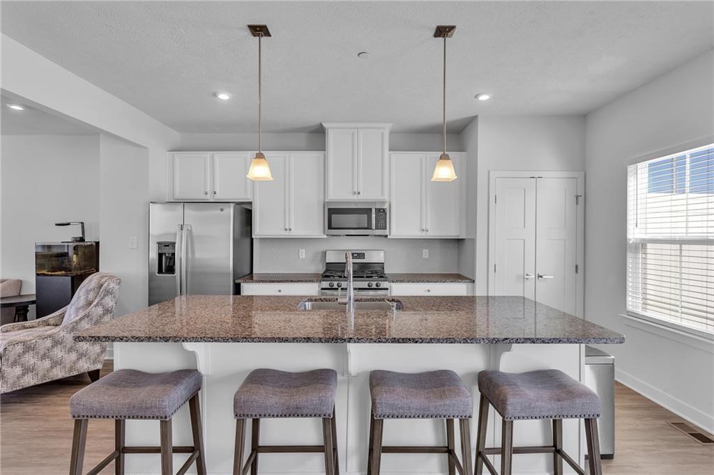 7406 Chestnut Way Gibsonia, PA 15044 - Photo 11 of 42 a kitchen with granite countertop kitchen island cabinets and stainless steel appliances