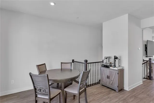 a view of a dining room with furniture and wooden floor