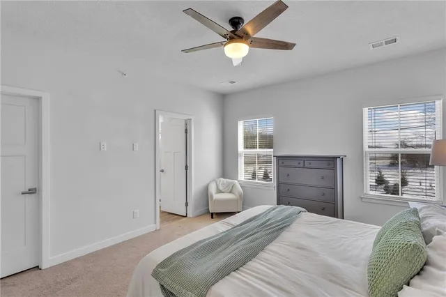 a bathroom with a double vanity sink toilet and a mirror