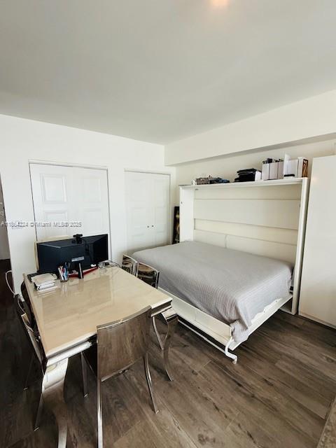 475 Brickell Avenue, Unit 4910 Miami, FL 33131 - Photo 8 of 42 a bedroom with a bed and a table in it