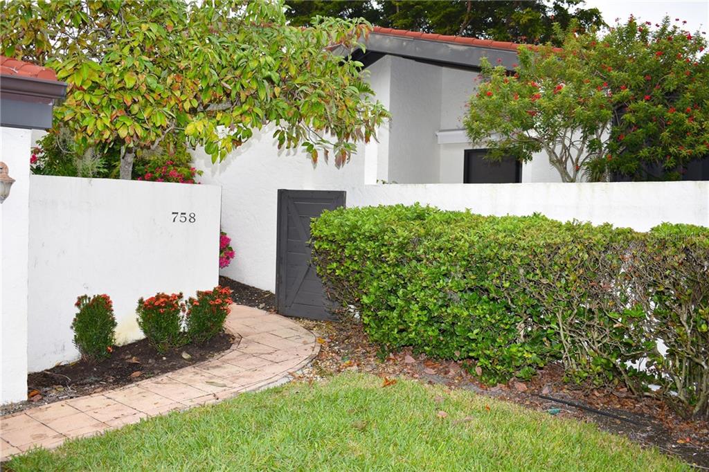 758 Sarabay Road, Unit 5 Osprey, FL 34229 - Photo 1 of 1 a view of a garden with a house