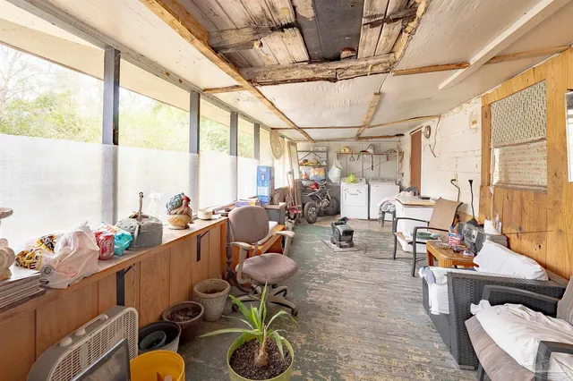 a bedroom with a bed and wooden cabinets