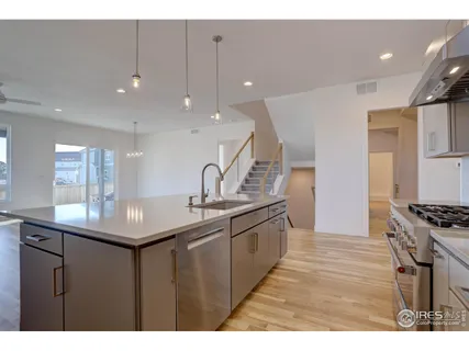 a kitchen with counter top space sink and appliances