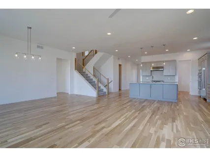 a view of kitchen and hall with wooden floor