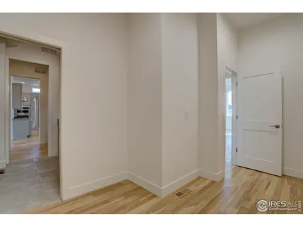 a view of an empty room and wooden floor