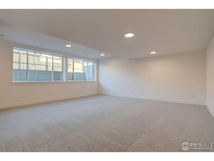 a view of an empty room with window and hallway