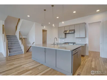 a view of kitchen with wooden floor and electronic appliances