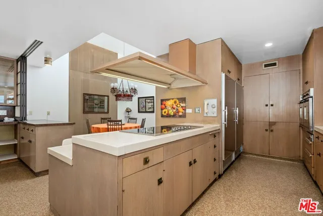 a kitchen with granite countertop a sink and cabinets
