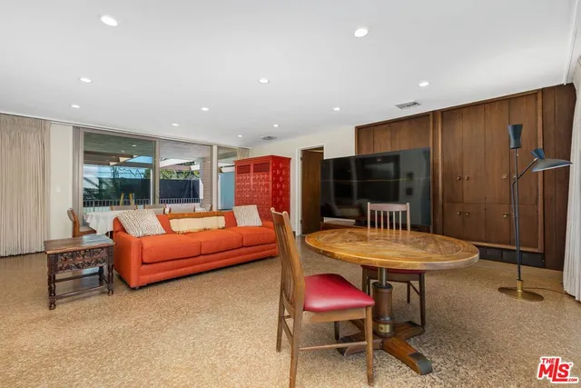 a spacious bedroom with a bed and a large window