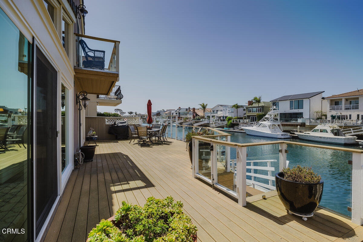 2231 Peninsula Road Oxnard, CA 93035 - Photo 1 of 40 a balcony with chairs and wooden floor