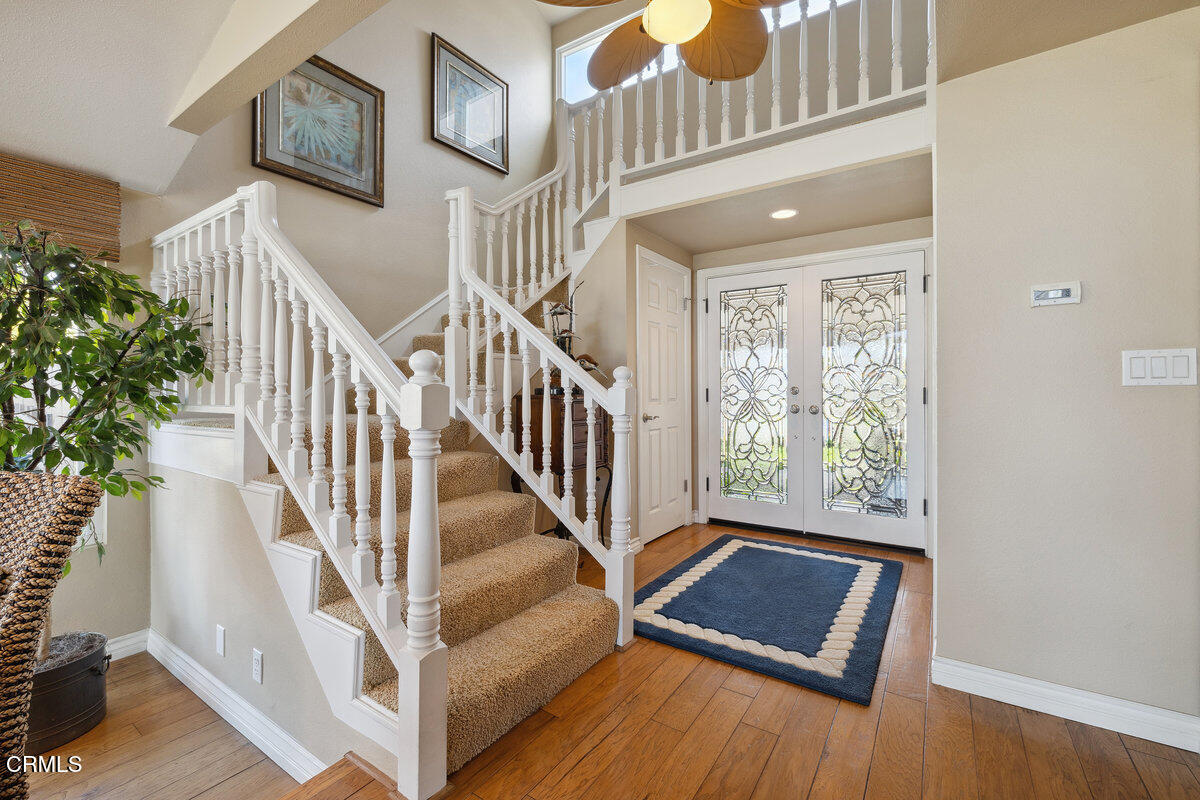 2231 Peninsula Road Oxnard, CA 93035 - Photo 20 of 40 a view of staircase with lots of frames on wall and a window