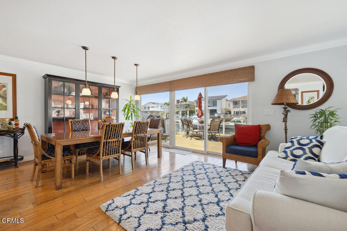 2231 Peninsula Road Oxnard, CA 93035 - Photo 6 of 40 a living room with furniture a dining table and a floor to ceiling window