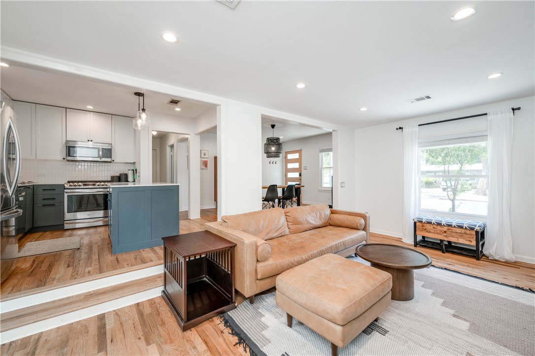 a living room with fireplace furniture and a wooden floor