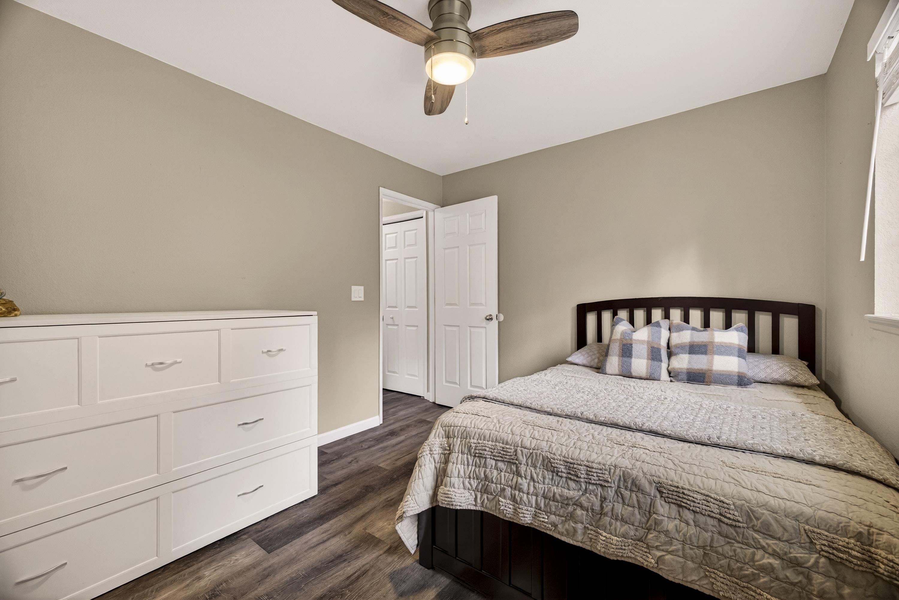 811 Golf Club Road Lake Almanor, CA 96137 - Photo 25 of 42 a bedroom with a large bed and a chandelier
